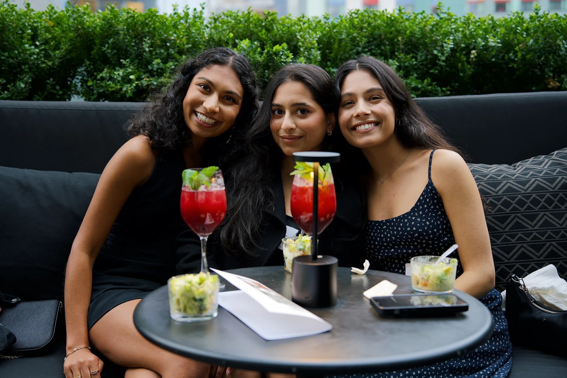 Guests sharing drinks and a portrait on the terrace