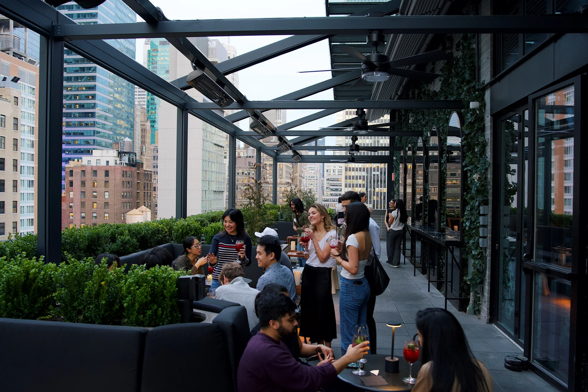 Guests gathered on the terrace with the city around them