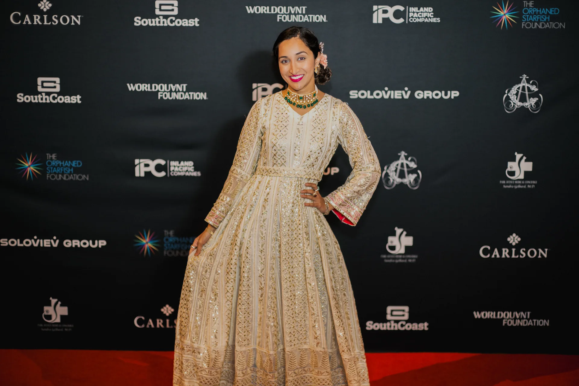 A guest portrait in a gold gown at the gala