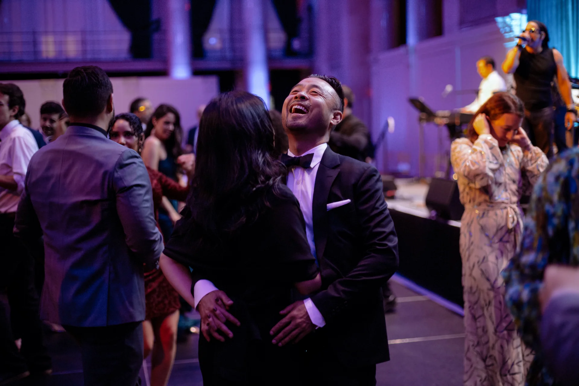 A guest laughing while dancing at the gala